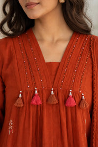 Warm rust Zariya mul cotton suit set with delicate detailing — close-up of weave and embroidery detail, RITAURA
